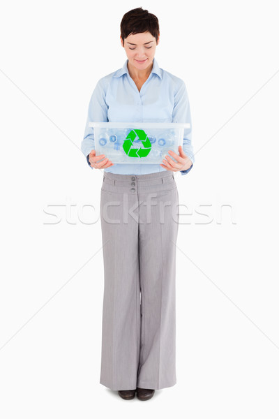 Businesswoman looking at a recycling box against a white background Stock photo © wavebreak_media
