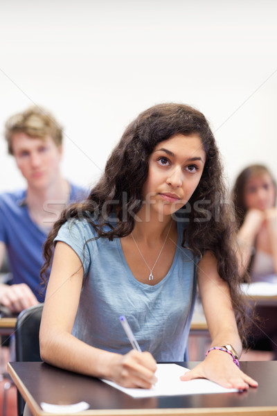 Portrait of a focused student taking notes in a classroom Stock photo © wavebreak_media