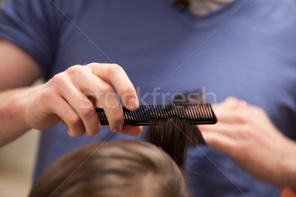 Hand combing hair with a comb Stock photo © wavebreak_media