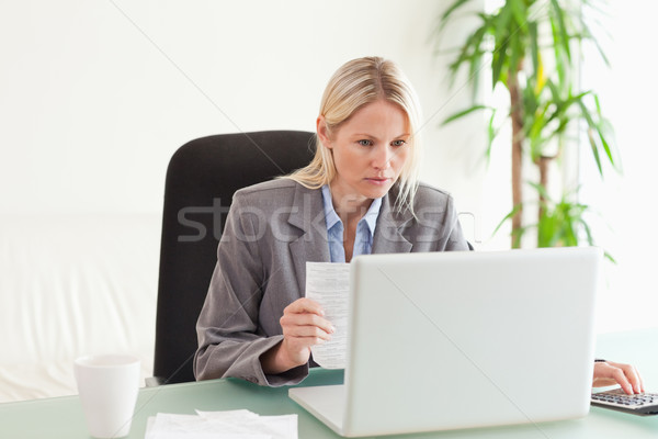 Concentrated businesswoman doing calculations Stock photo © wavebreak_media