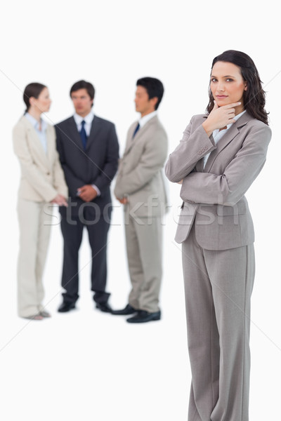Thinking saleswoman with team behind her against a white background Stock photo © wavebreak_media