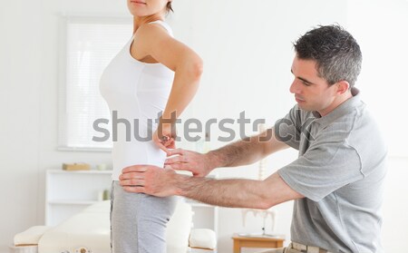 Woman lying while being stretched by a man in a room Stock photo © wavebreak_media