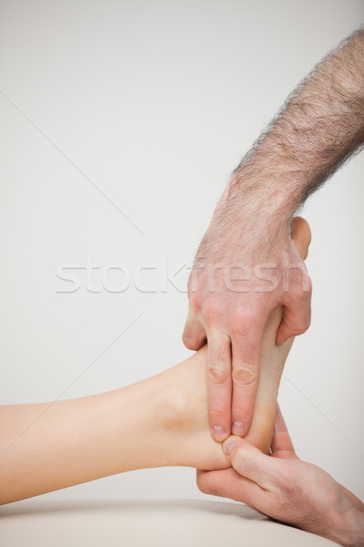 Two fingers pressing the Achilles tendon of a patient in a room Stock photo © wavebreak_media