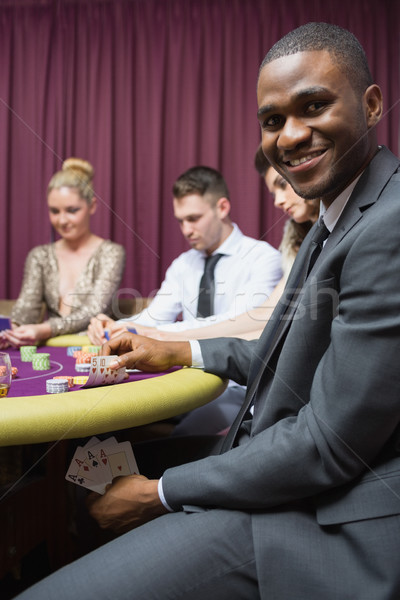 Man showing poker hand under table at casino Stock photo © wavebreak_media