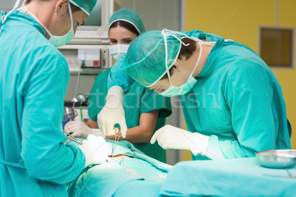 Surgeons working with a scissors on a patient Stock photo © wavebreak_media