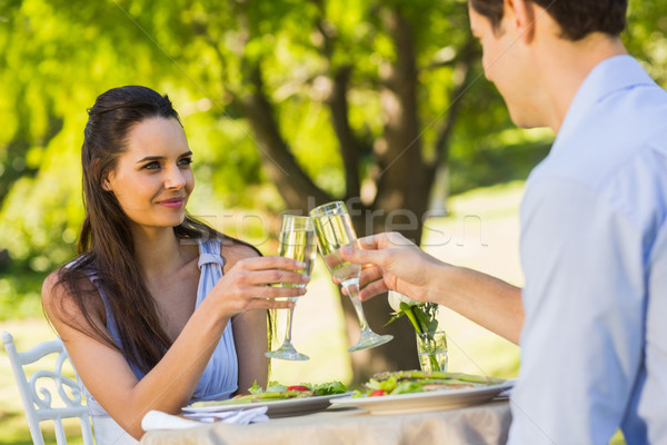Couple toasting champagne flutes at an outdoor cafÃ© Stock photo © wavebreak_media