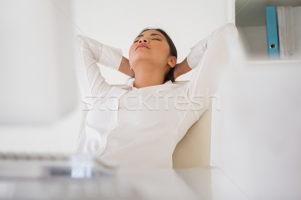 Casual businesswoman napping at her desk Stock photo © wavebreak_media