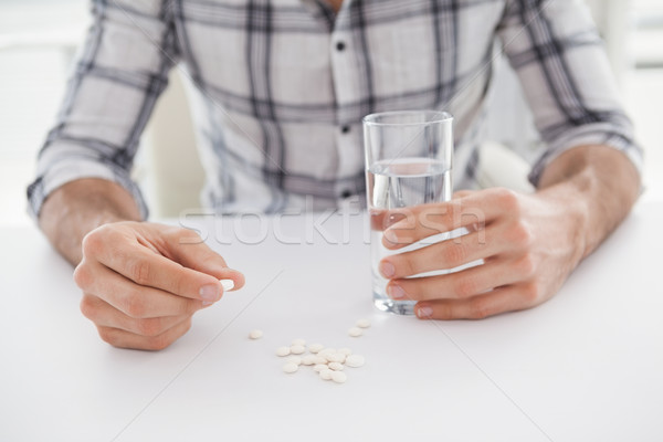 Casual businessman holding glass of water and tablet Stock photo © wavebreak_media
