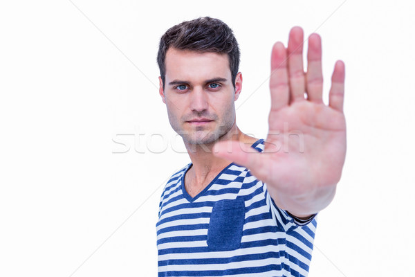 Handsome hipster looking at camera and showing stop sign with ha Stock photo © wavebreak_media