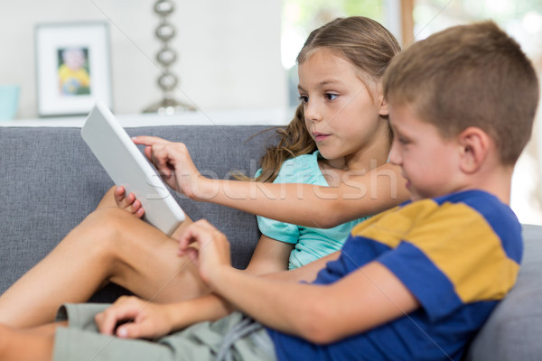 Siblings using digital tablet in living room Stock photo © wavebreak_media