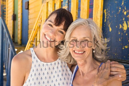 Portrait of cheerful mother and daughter standing against hut Stock photo © wavebreak_media
