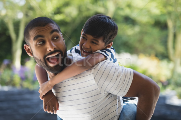 Happy father piggybacking his son at porch Stock photo © wavebreak_media