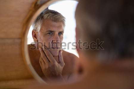 Man looking at mirror in cottage Stock photo © wavebreak_media