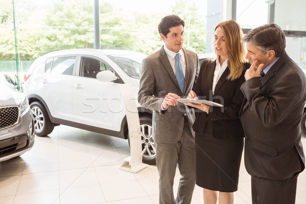 Sales team look at a clipboard Stock photo © wavebreak_media