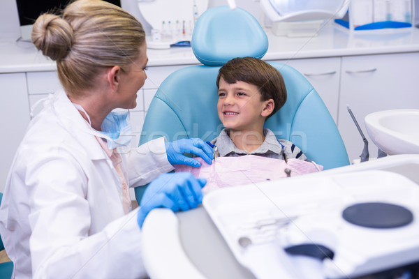 Side view of dentist talking with boy Stock photo © wavebreak_media