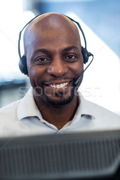 Man working on computer with headset Stock photo © wavebreak_media