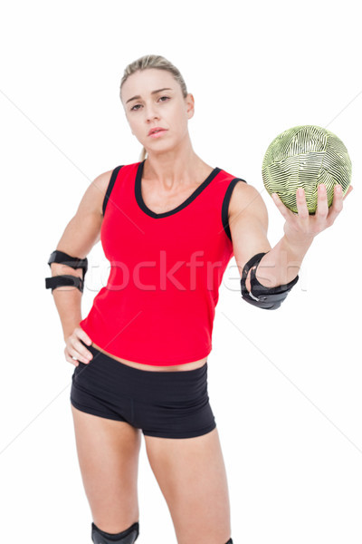 Stock photo: Female athlete with elbow pad holding handball