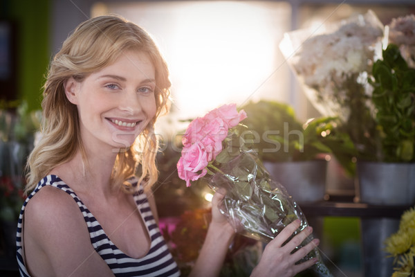 Female florist holding bunch of flower in flower shop Stock photo © wavebreak_media