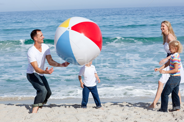 Animado familia jugando pelota playa sonrisa Foto stock © wavebreak_media