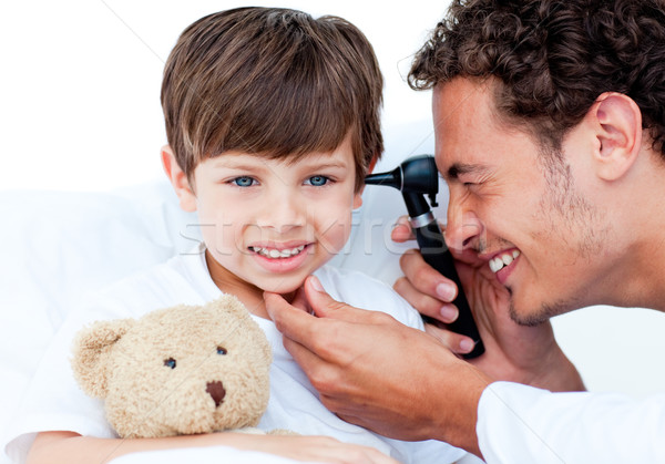 Attractive doctor examining patient's ears Stock photo © wavebreak_media