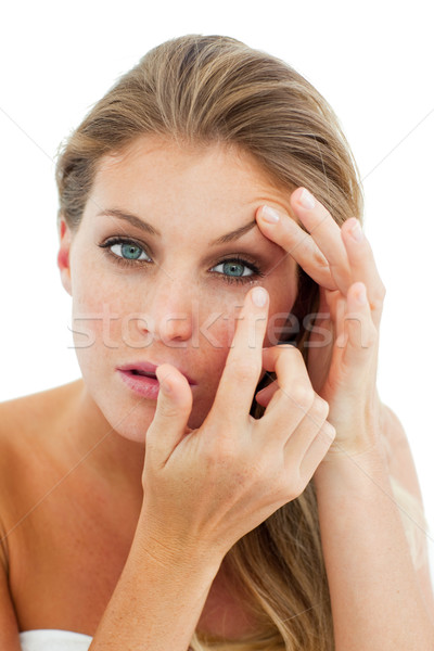 Konzentrierter Frau Kontaktlinsen isoliert weiß Auge Stock foto © wavebreak_media