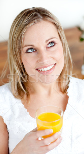 Portrait of a radiant woman holding an orange juice  Stock photo © wavebreak_media