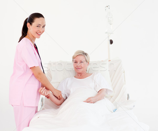 Mosolyog nővér beteg néz kamera kórház Stock fotó © wavebreak_media
