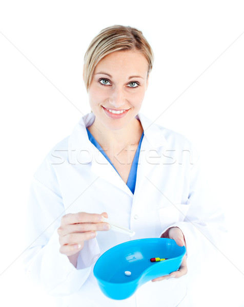 Charismatic female doctor holding capsule against white background Stock photo © wavebreak_media