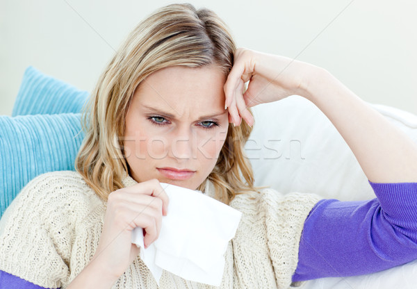 Diseased woman lying on a sofa with tissues against a white background Stock photo © wavebreak_media