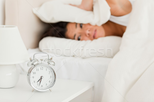 goodlooking woman waking under sheet not wanting to hear alarm clock in bedroom Stock photo © wavebreak_media