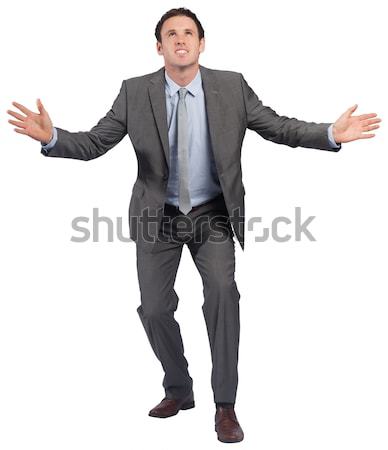 Portrait of a businessman pointing behind him against white background Stock photo © wavebreak_media