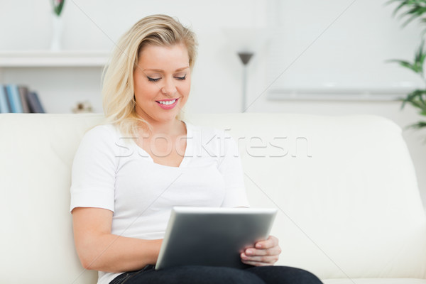 Casual woman using a tablet pc in a living room Stock photo © wavebreak_media