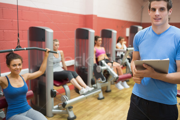 Trainer in weights room with women in gym Stock photo © wavebreak_media