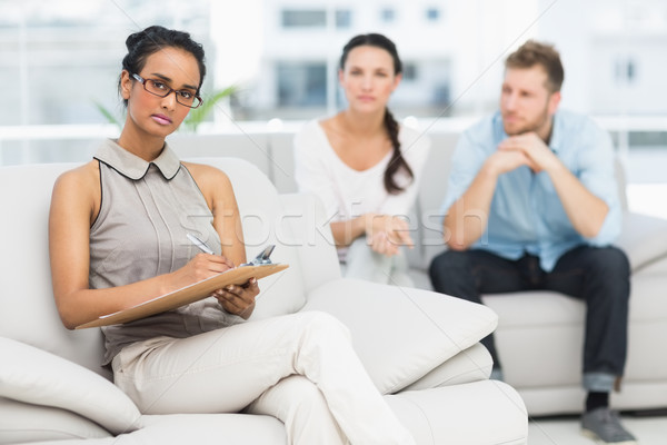 Stock photo: Portrait of serious therapist and unhappy couple