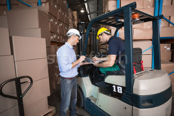 Warehouse manager talking with forklift driver Stock photo © wavebreak_media