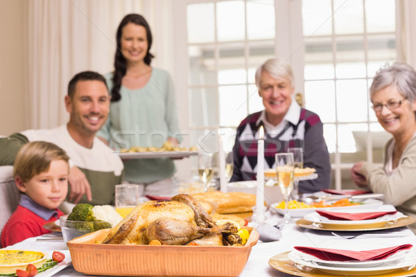 Woman holding christmas dinner with family at dinning table Stock photo © wavebreak_media