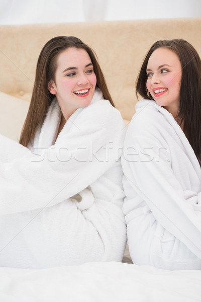 Pretty friends wearing white bathrobes Stock photo © wavebreak_media