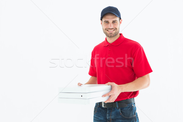 Happy delivery man holding pizza boxes Stock photo © wavebreak_media