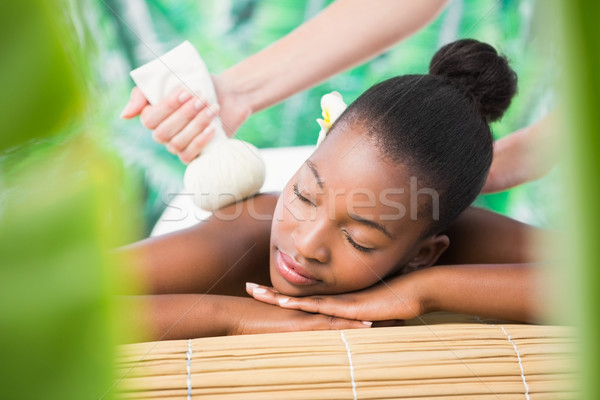 Pretty woman enjoying a herbal compress massage Stock photo © wavebreak_media