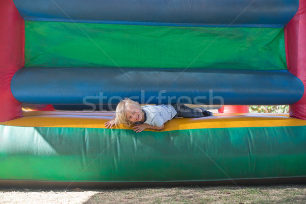 Portrait of happy boy playing on bouncy castle Stock photo © wavebreak_media