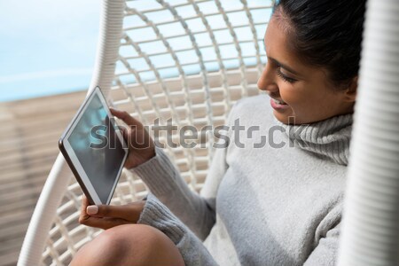 Stock photo: Thoughtful woman relaxing in swing