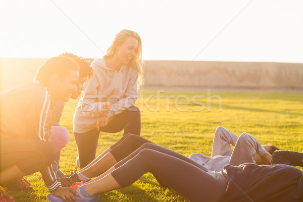 Stock photo: Sporty women doing sit ups during fitness class