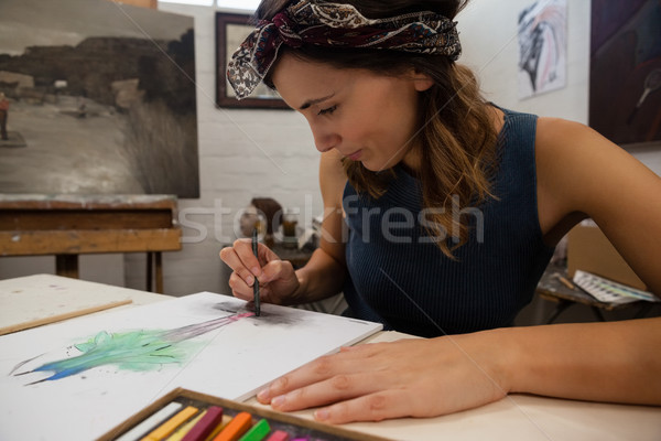 Woman drawing on book in drawing class Stock photo © wavebreak_media