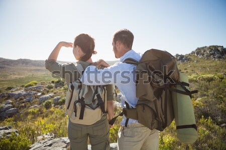 Woman with man pointing on off road vehicle with tire Stock photo © wavebreak_media
