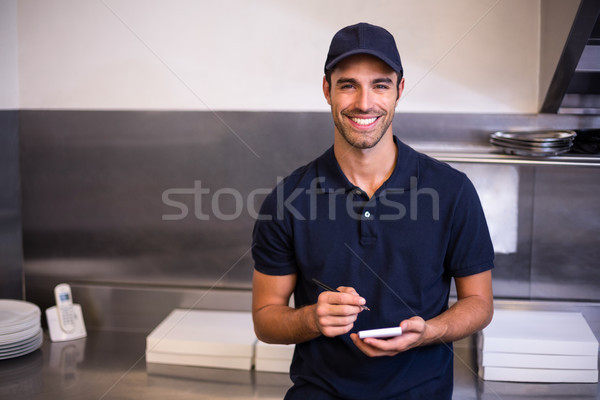 Pizza delivery man taking an order Stock photo © wavebreak_media