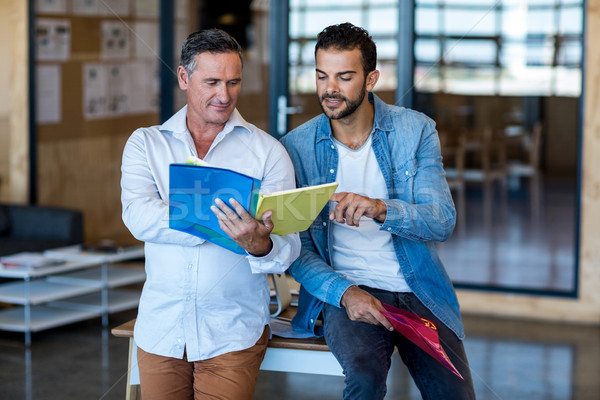 Collègues regarder fichier bureau papier homme [[stock_photo]] © wavebreak_media