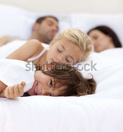 [[stock_photo]]: Petite · fille · souriant · lit · famille · dormir · belle