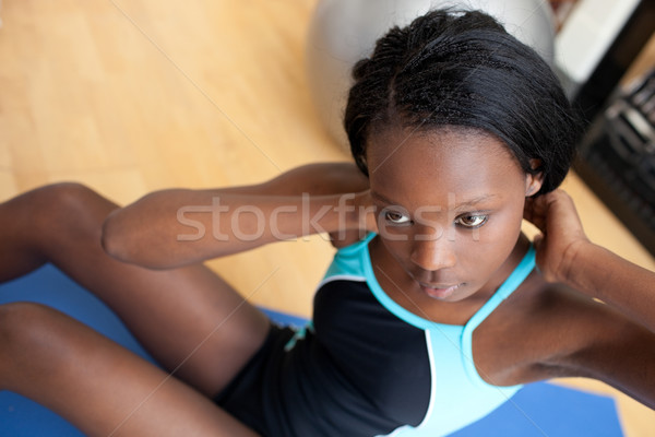 Serious ethnic woman in gym clothes working out Stock photo © wavebreak_media