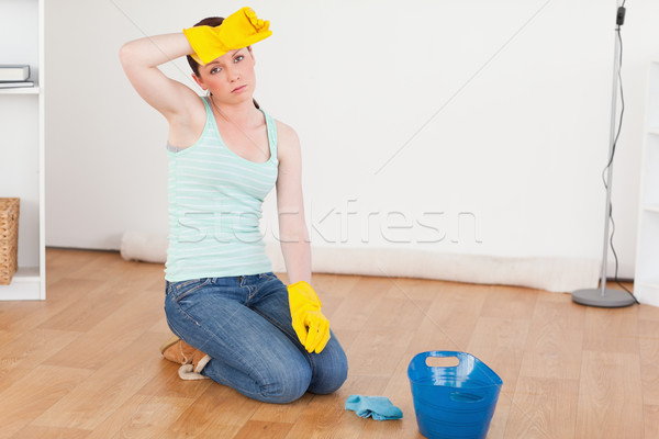 Cute red-haired woman having a break while cleaning the floor at home Stock photo © wavebreak_media