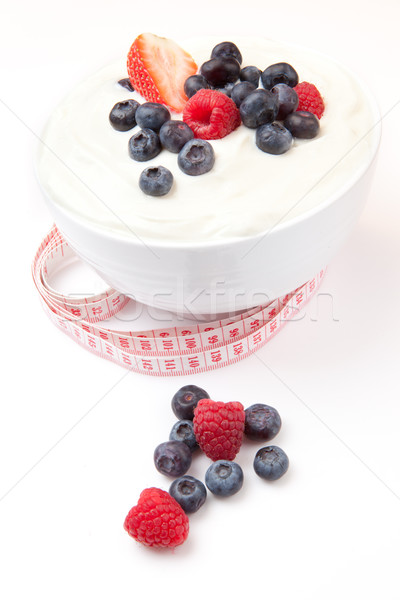 Tape measure and berries cream against a white background Stock photo © wavebreak_media